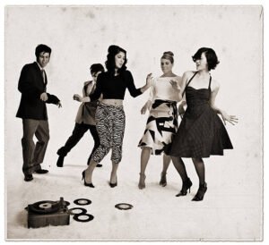 1950's image of a small group of young people dancing with a record player near by - represents freedom